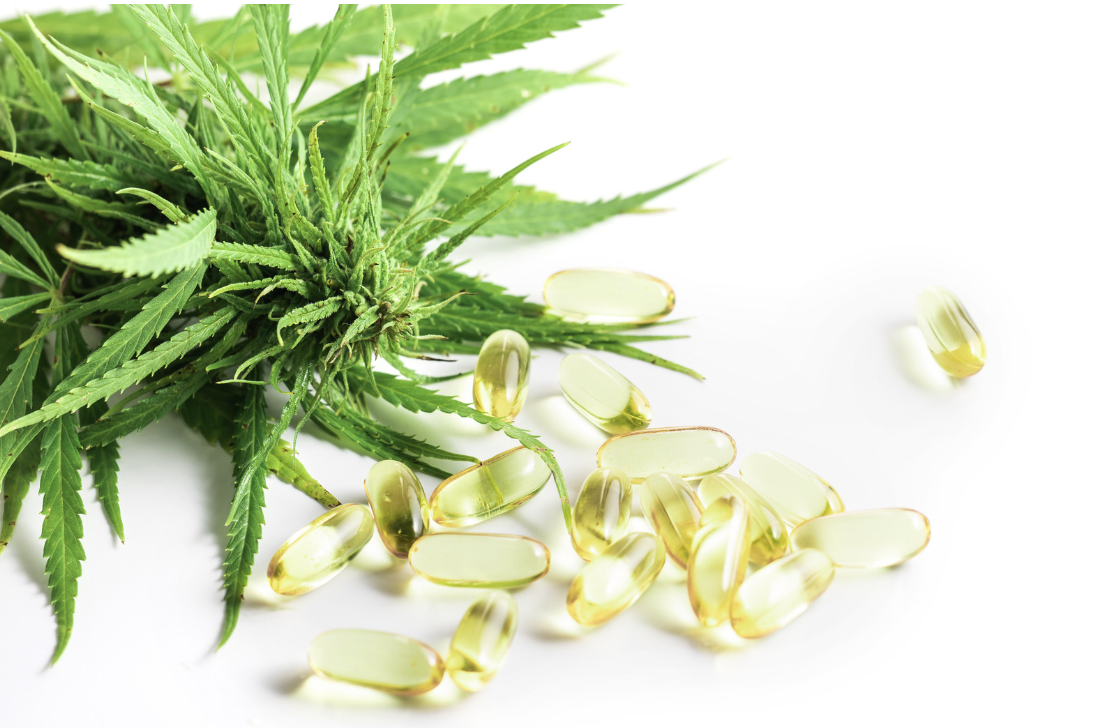 thc capsules on white background with weed leaf